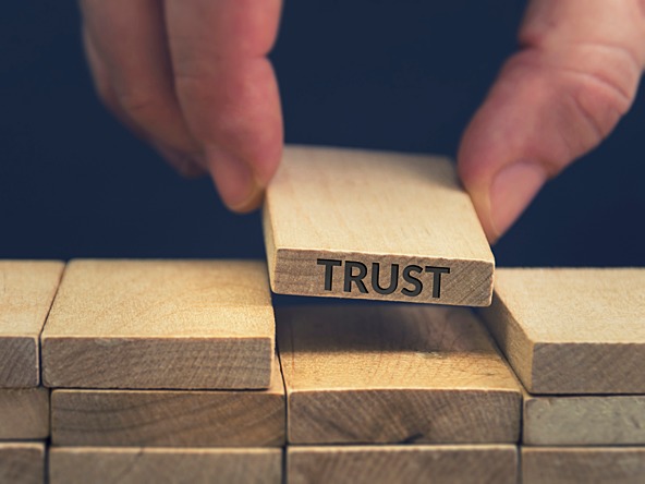 Wooden brick spelling 'trust'